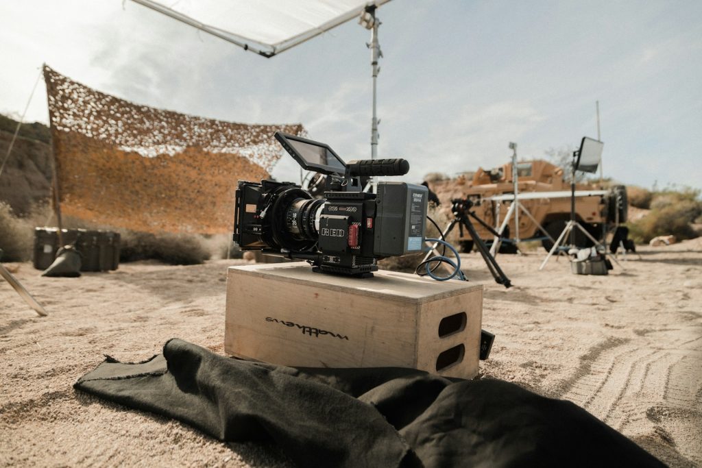 A black camera on a brown cardboard box capturing a video testimonial